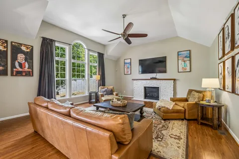 a bedroom with a large bed and ceiling fan