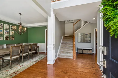 a view of a dining room with furniture wooden floor and a chandelier