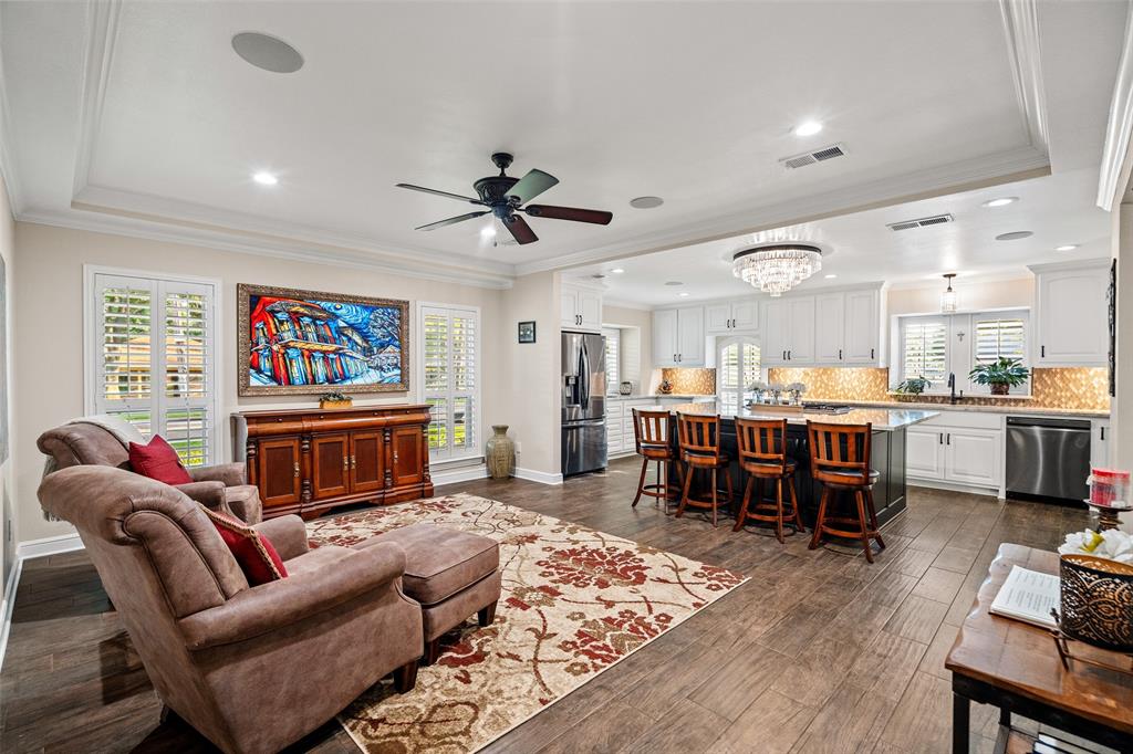 400 Hunters Ridge Circle Coppell, TX 75019 - Photo 11 of 35 a living room with furniture kitchen view and a flat screen tv