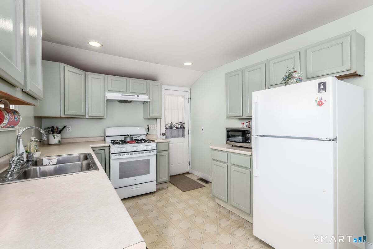 70 Dodgingtown Road Bethel, CT 06801 - Photo 8 of 27 a kitchen with a white cabinets and refrigerator