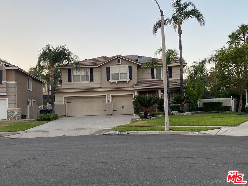 12866 Tilden Drive Rancho Cucamonga, CA 91739 - Photo 1 of 1 a front view of a house with garden and trees
