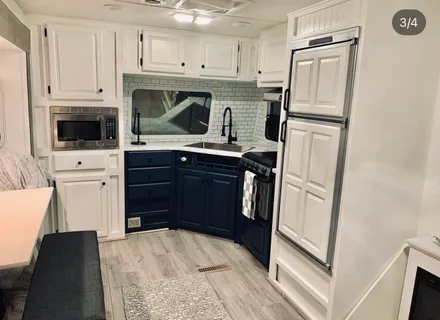 a kitchen with a refrigerator and a stove