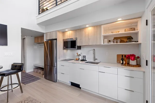 a kitchen with a refrigerator and cabinets