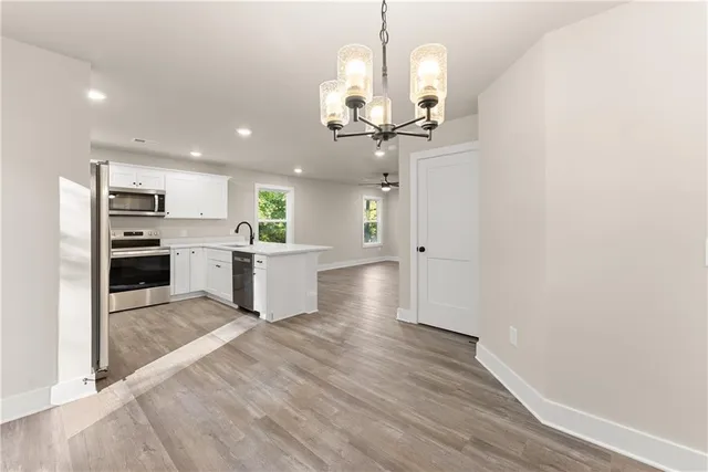 a view of a kitchen with a sink stainless steel appliances and cabinets