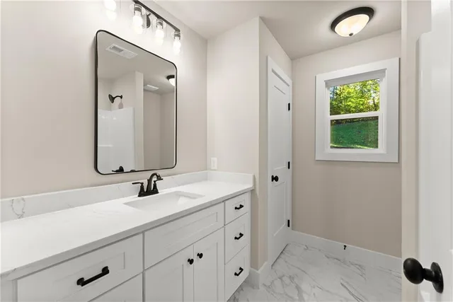 a bathroom with a double vanity sink and mirror
