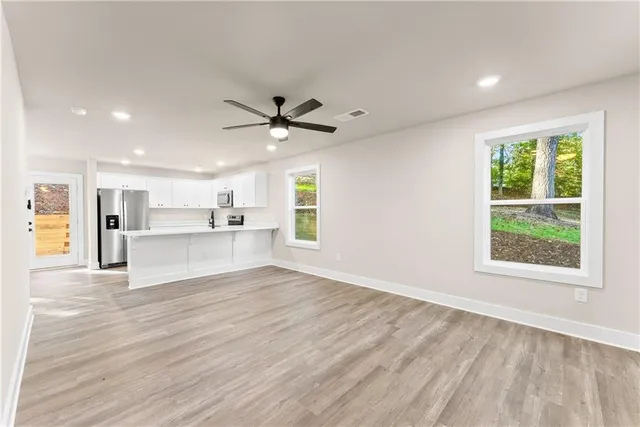 a view of a kitchen with a sink and a window