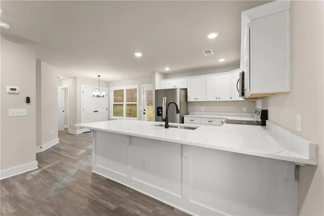 a kitchen with stainless steel appliances sink refrigerator and cabinets