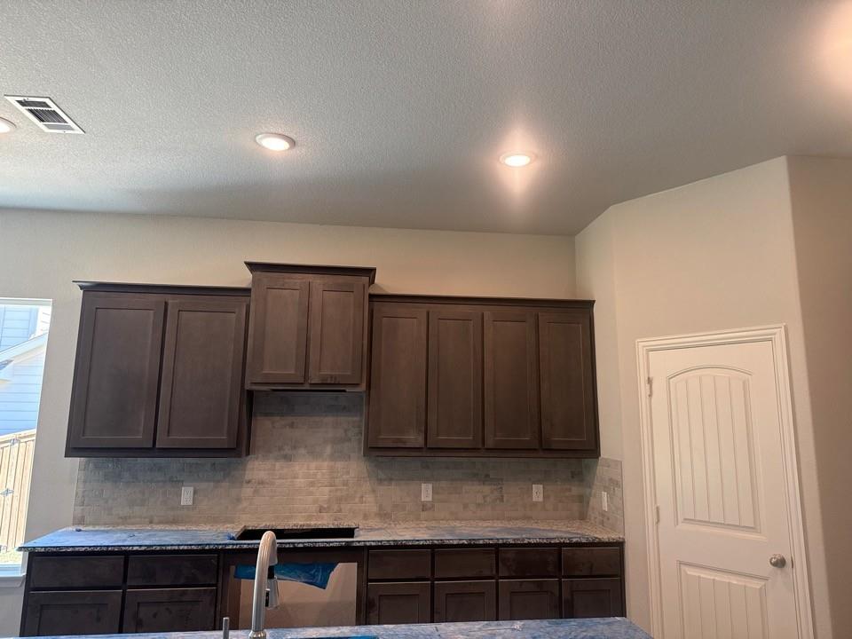 404 Guadalupe Lane Springtown, TX 76082 - Photo 3 of 9 a kitchen with granite countertop cabinets and wooden floor