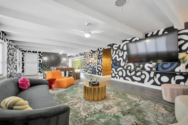 a glass room with furniture and a rug