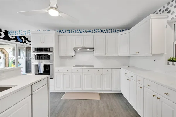 a kitchen with stainless steel appliances cabinets and a center island