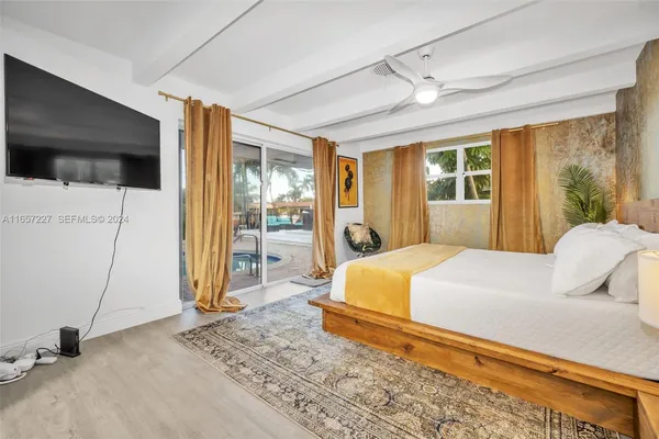 a bedroom with a bed and a large window