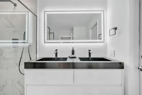 a kitchen with a sink and a mirror