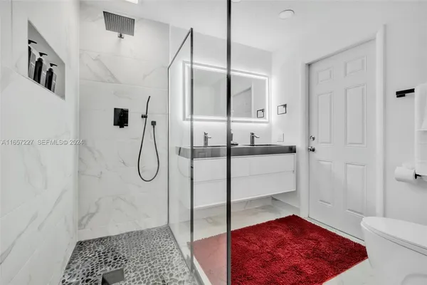 a bathroom with a shower and a sink