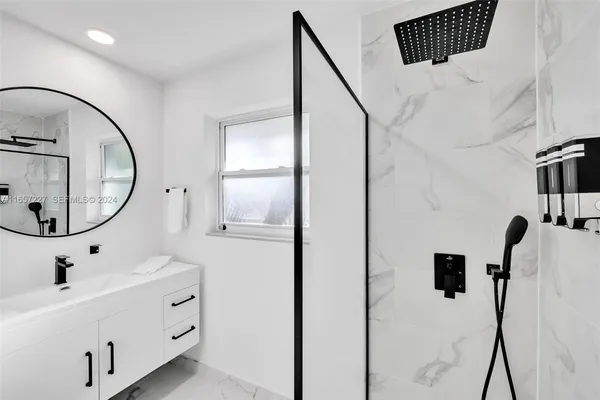 a bathroom with a sink mirror and vanity