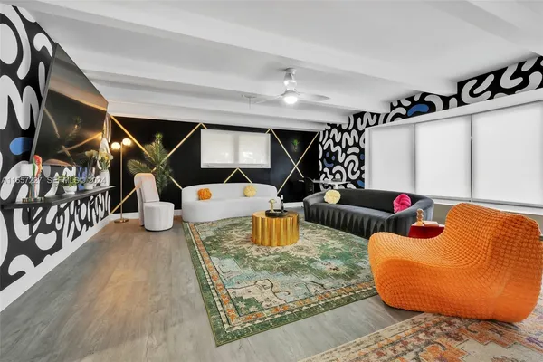 a living room with furniture and kitchen view