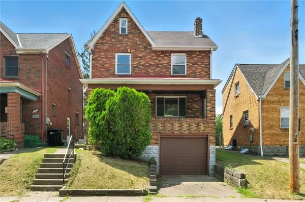front view of a house with a yard