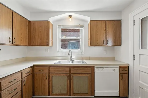 a kitchen with a sink cabinets and window