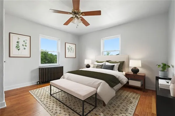 a bedroom with a bed a couch and window