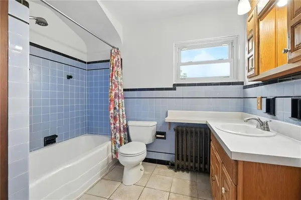 a bathroom with a sink a toilet and bathtub