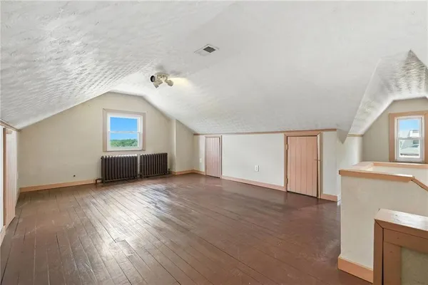 a view of a livingroom with wooden floor and a ceiling fan