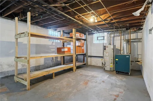 a view of an empty room with wooden ceiling