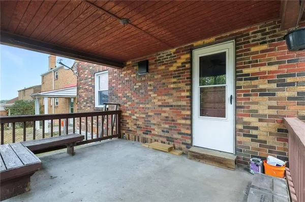 a view of a porch with furniture and a window