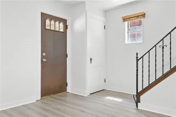 a view of an entryway with wooden floor