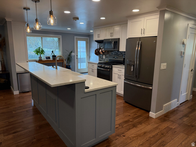 362 East 9150th Street South Sandy, UT 84070 - Photo 5 of 41 Kitchen featuring stainless steel refrigerator with ice dispenser, range with gas stovetop, solid hickory flooring , an island with farm sink, and backsplash
