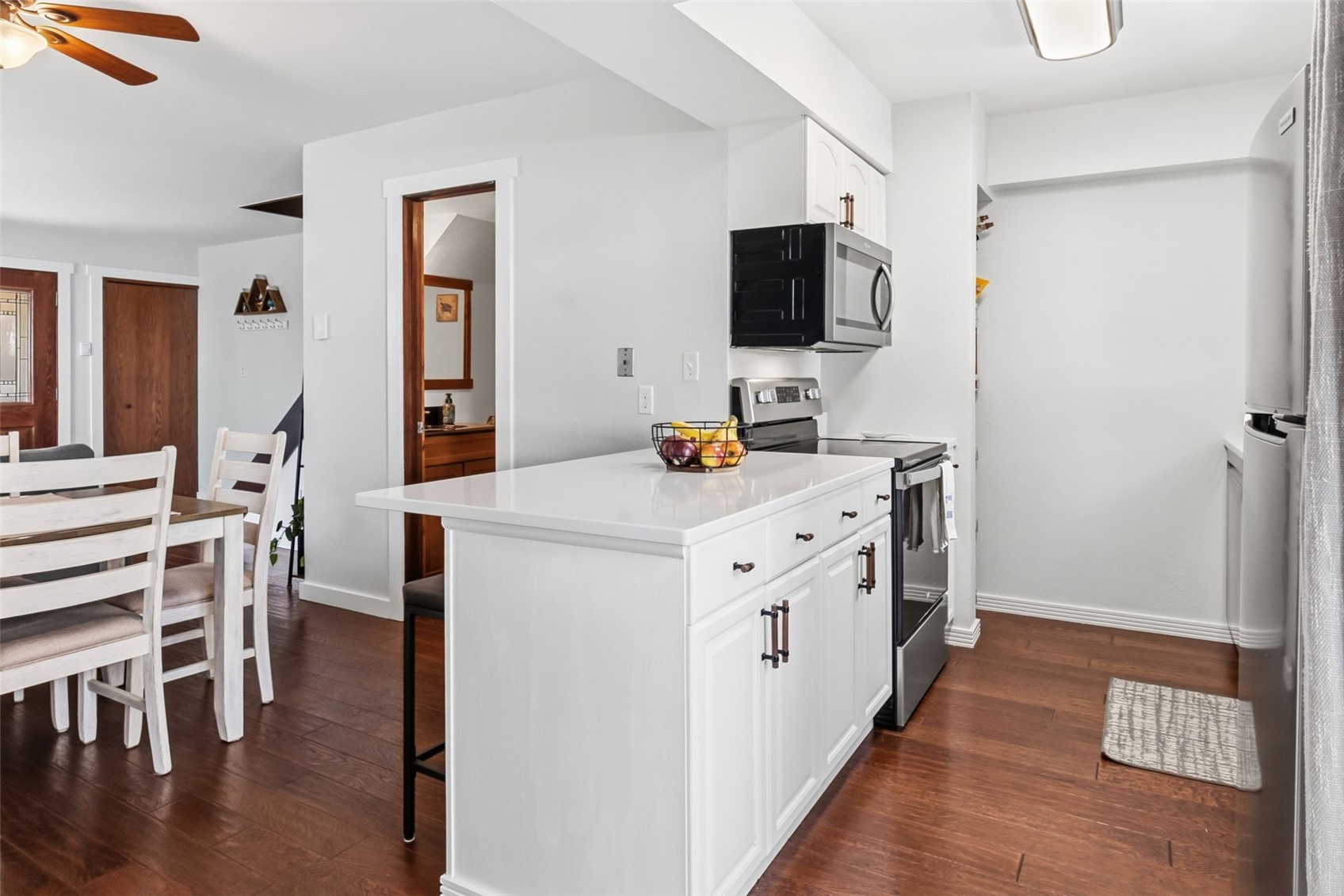 6920 Ryan Gulch Road, Unit 6920 Silverthorne, CO 80498 - Photo 15 of 48 a kitchen with stainless steel appliances a stove top oven a sink a refrigerator with wooden floor and cabinets