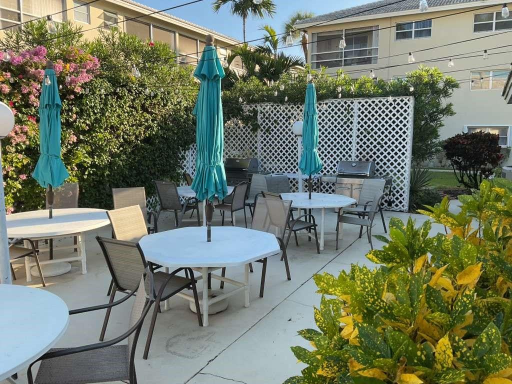 1951 Northeast 39th Street, Unit 361 Lighthouse Point, FL 33064 - Photo 20 of 27 a view of a patio with a table and chairs