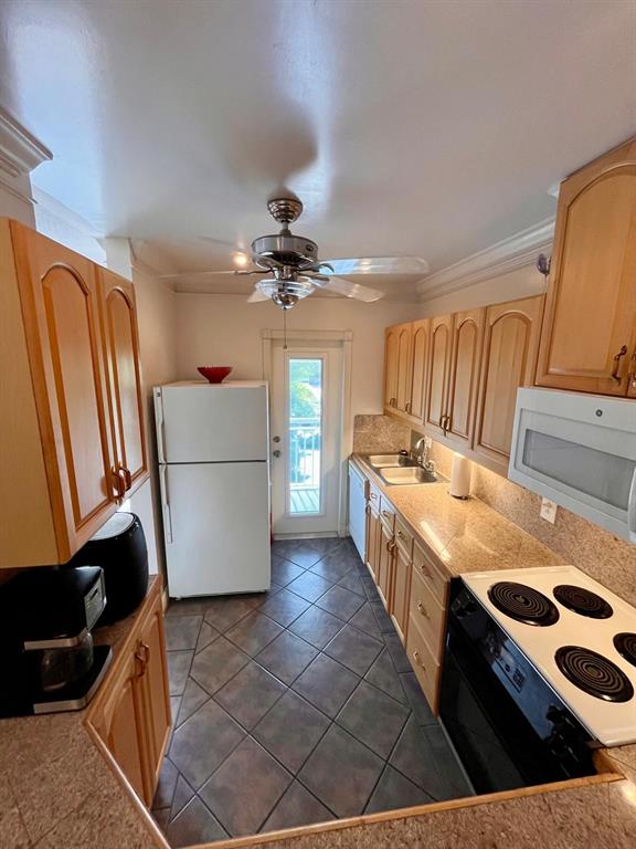 1951 Northeast 39th Street, Unit 361 Lighthouse Point, FL 33064 - Photo 2 of 27 a kitchen with stainless steel appliances granite countertop a sink counter space and cabinets