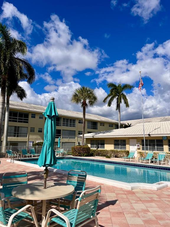 1951 Northeast 39th Street, Unit 361 Lighthouse Point, FL 33064 - Photo 22 of 27 a view of a swimming pool with a patio