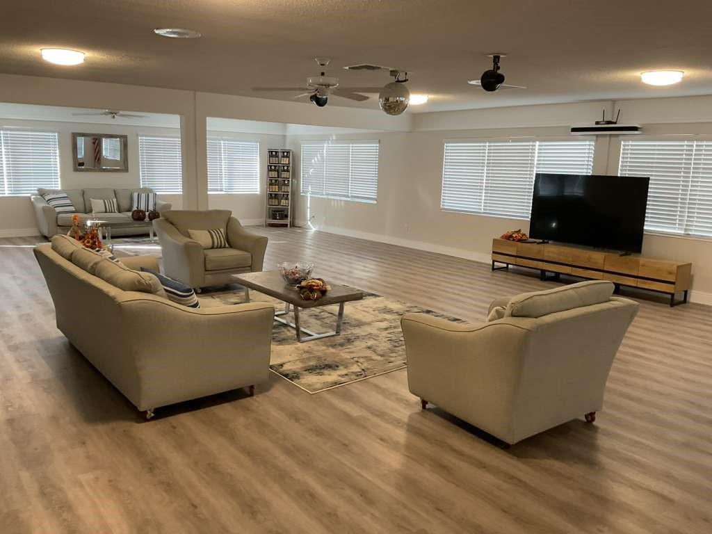 1951 Northeast 39th Street, Unit 361 Lighthouse Point, FL 33064 - Photo 23 of 27 a living room with furniture and a flat screen tv