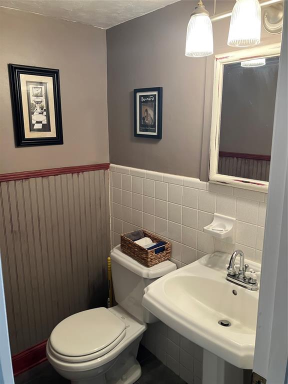 1951 Northeast 39th Street, Unit 361 Lighthouse Point, FL 33064 - Photo 6 of 27 a bathroom with a sink a toilet and mirror