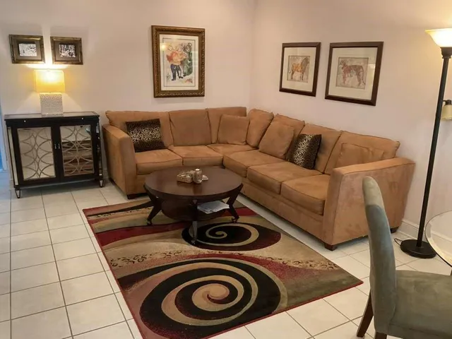 a living room with furniture and painting on the wall