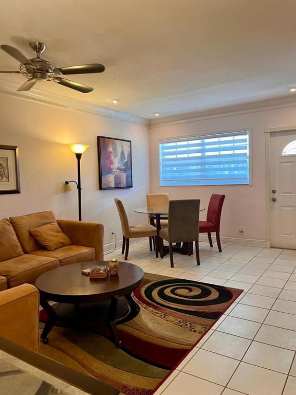 1951 Northeast 39th Street, Unit 361 Lighthouse Point, FL 33064 - Photo 8 of 27 a living room with furniture and painting on the wall