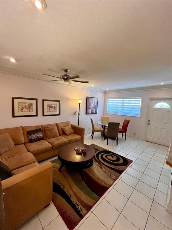 1951 Northeast 39th Street, Unit 361 Lighthouse Point, FL 33064 - Photo 9 of 27 a living room with furniture and a table