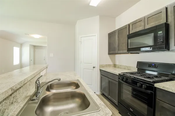 a bathroom with a granite countertop sink toilet tub and shower