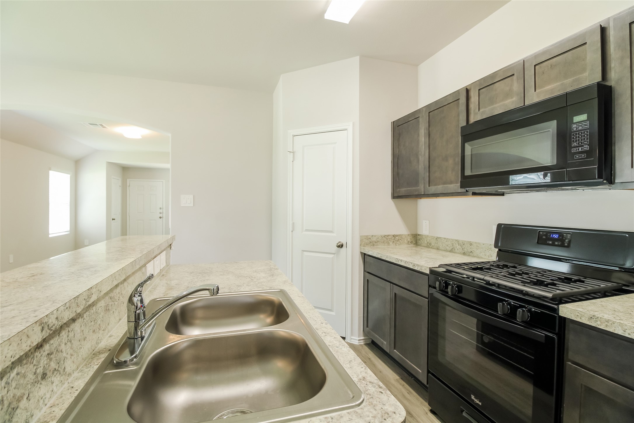 2553 Coho Drive Conroe, TX 77384 - Photo 6 of 14 a kitchen with granite countertop a sink and a stove top oven