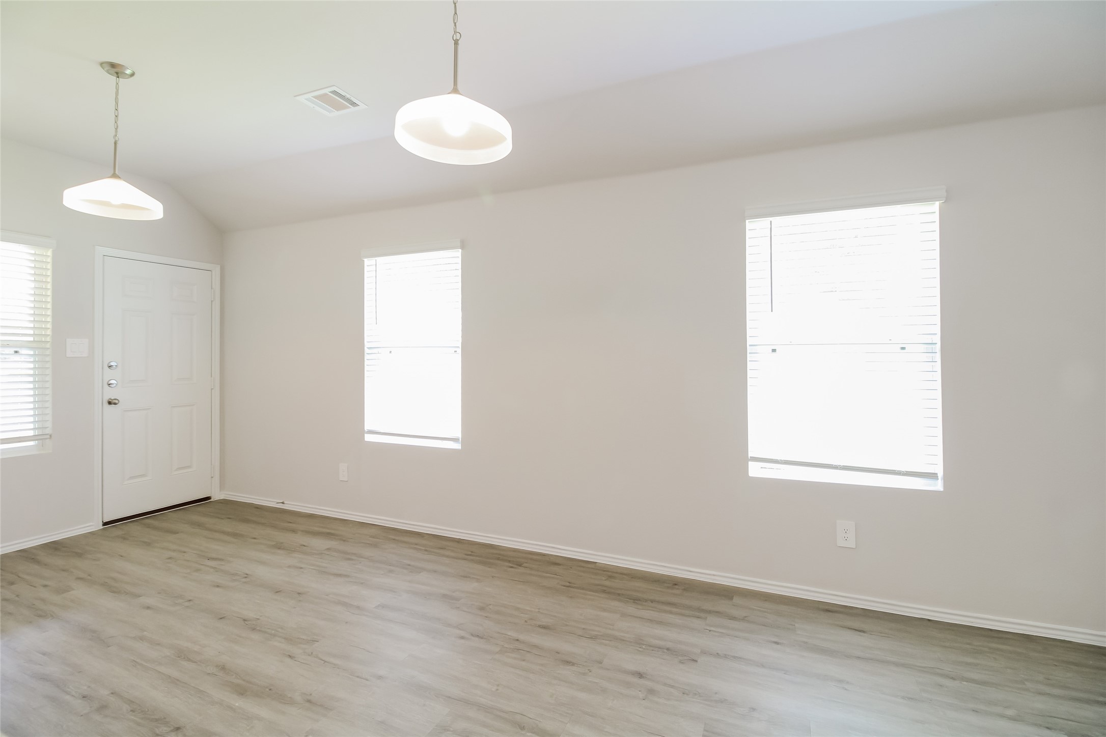 2553 Coho Drive Conroe, TX 77384 - Photo 8 of 14 an empty room with wooden floor and windows