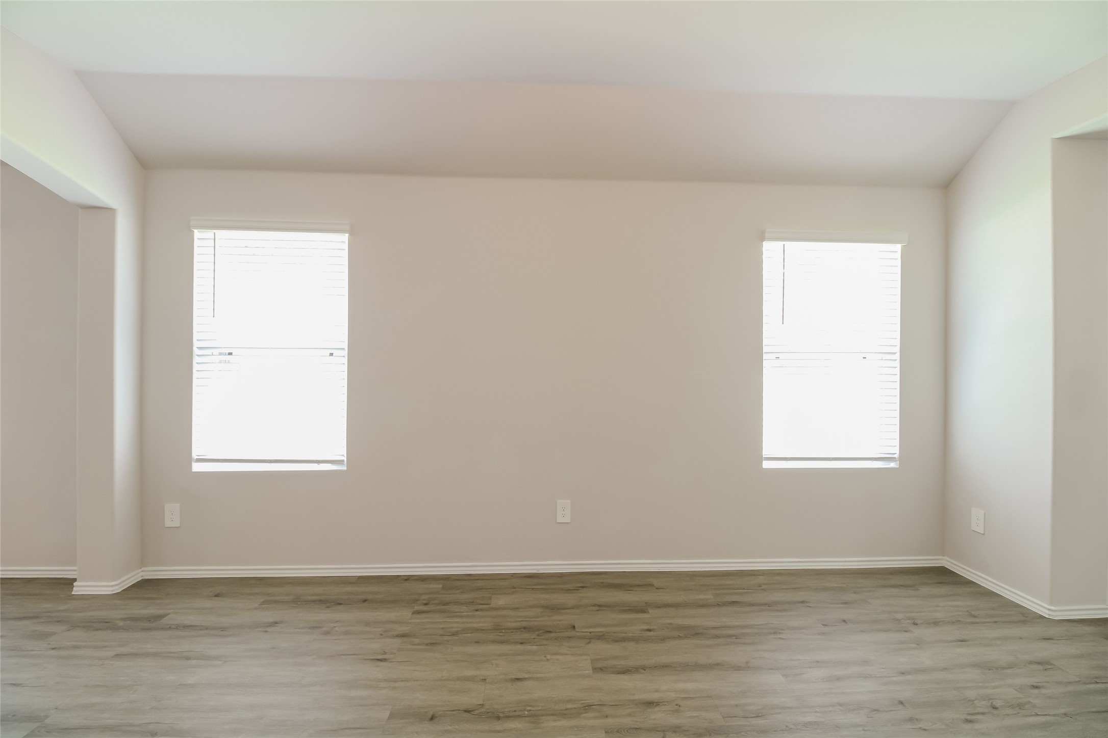 2553 Coho Drive Conroe, TX 77384 - Photo 9 of 14 an empty room with wooden floor and windows