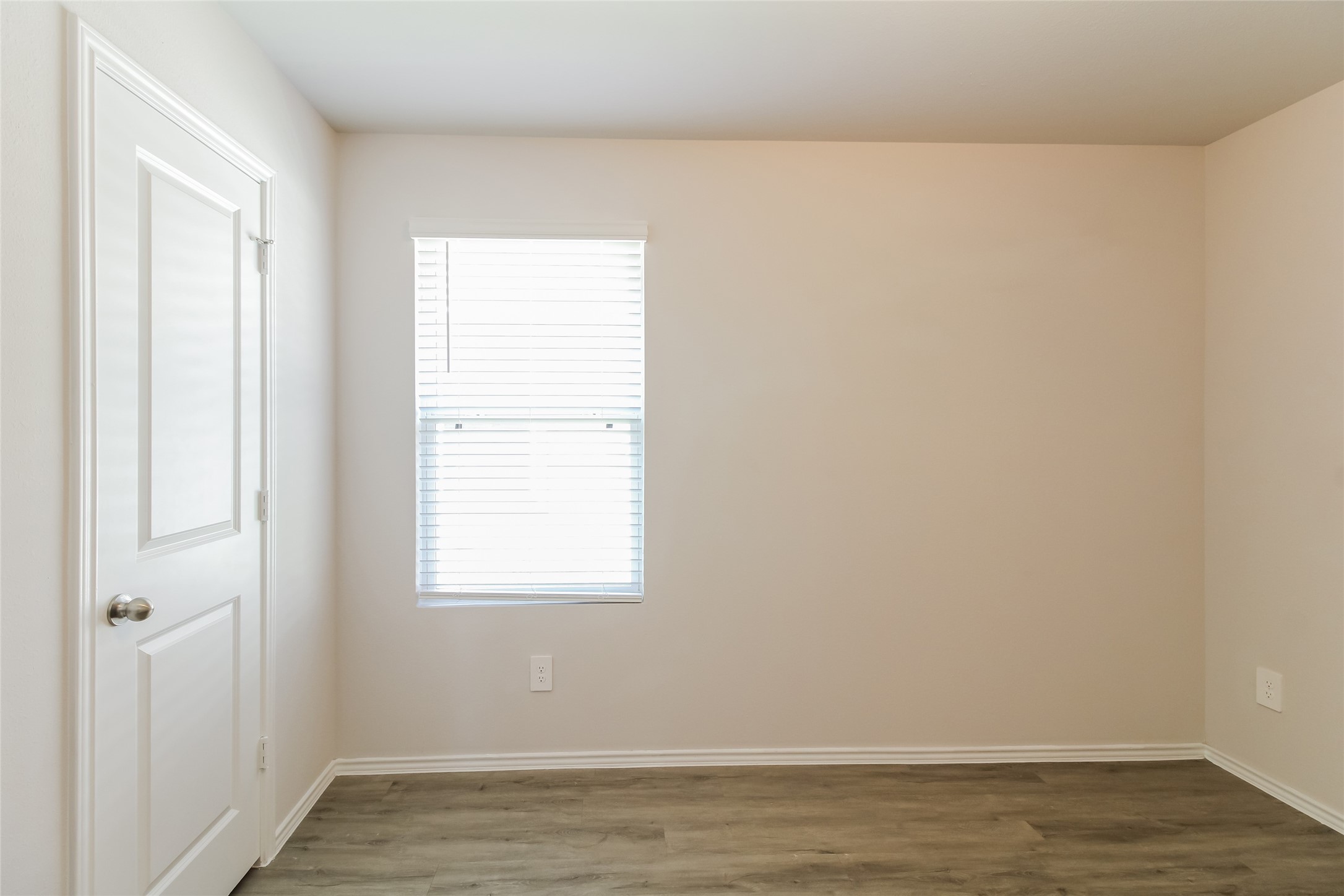 2553 Coho Drive Conroe, TX 77384 - Photo 12 of 14 a view of an empty room with wooden floor and a window