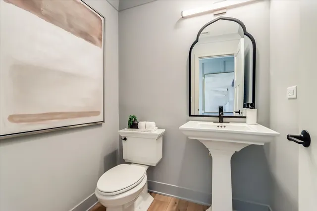 a bathroom with a toilet sink and mirror