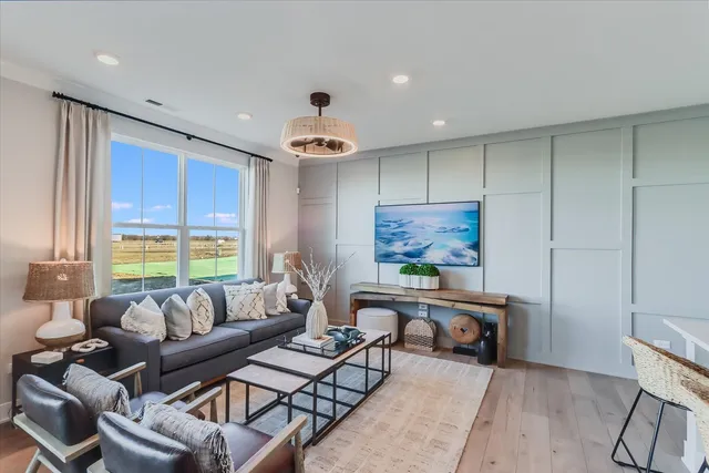 a living room with furniture and a large window