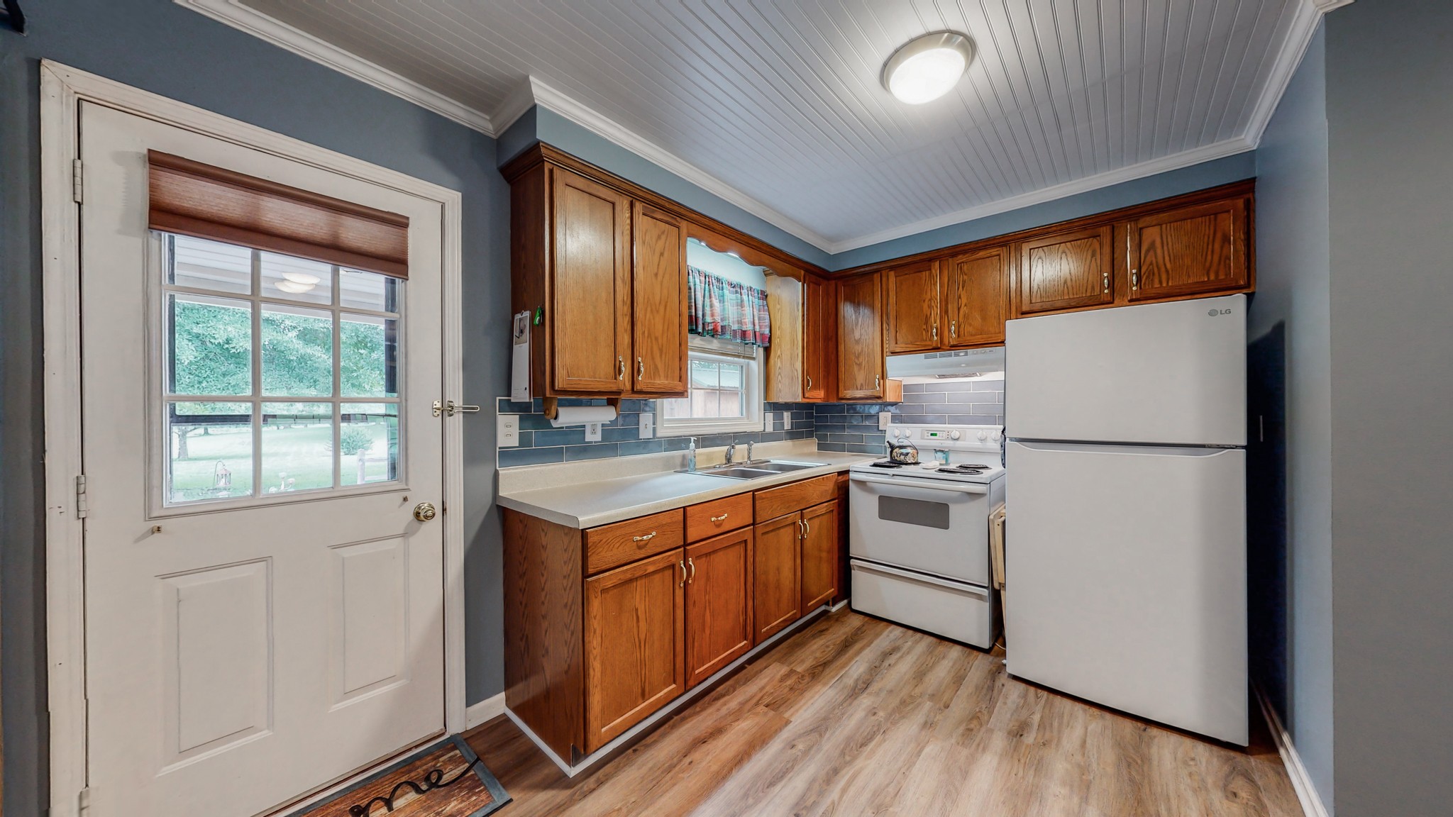 1243 White Road Bon Aqua, TN 37025 - Photo 11 of 42 a kitchen with a refrigerator sink and cabinets