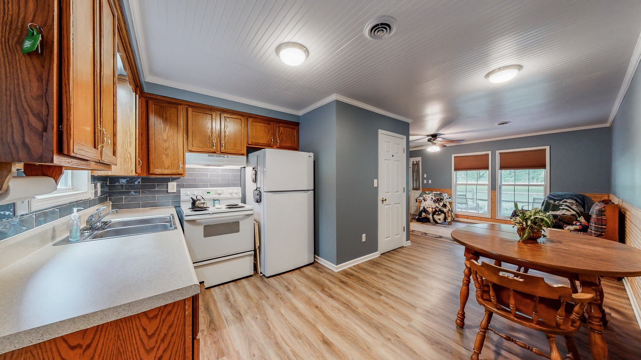 1243 White Road Bon Aqua, TN 37025 - Photo 13 of 42 a kitchen with sink a refrigerator and chairs