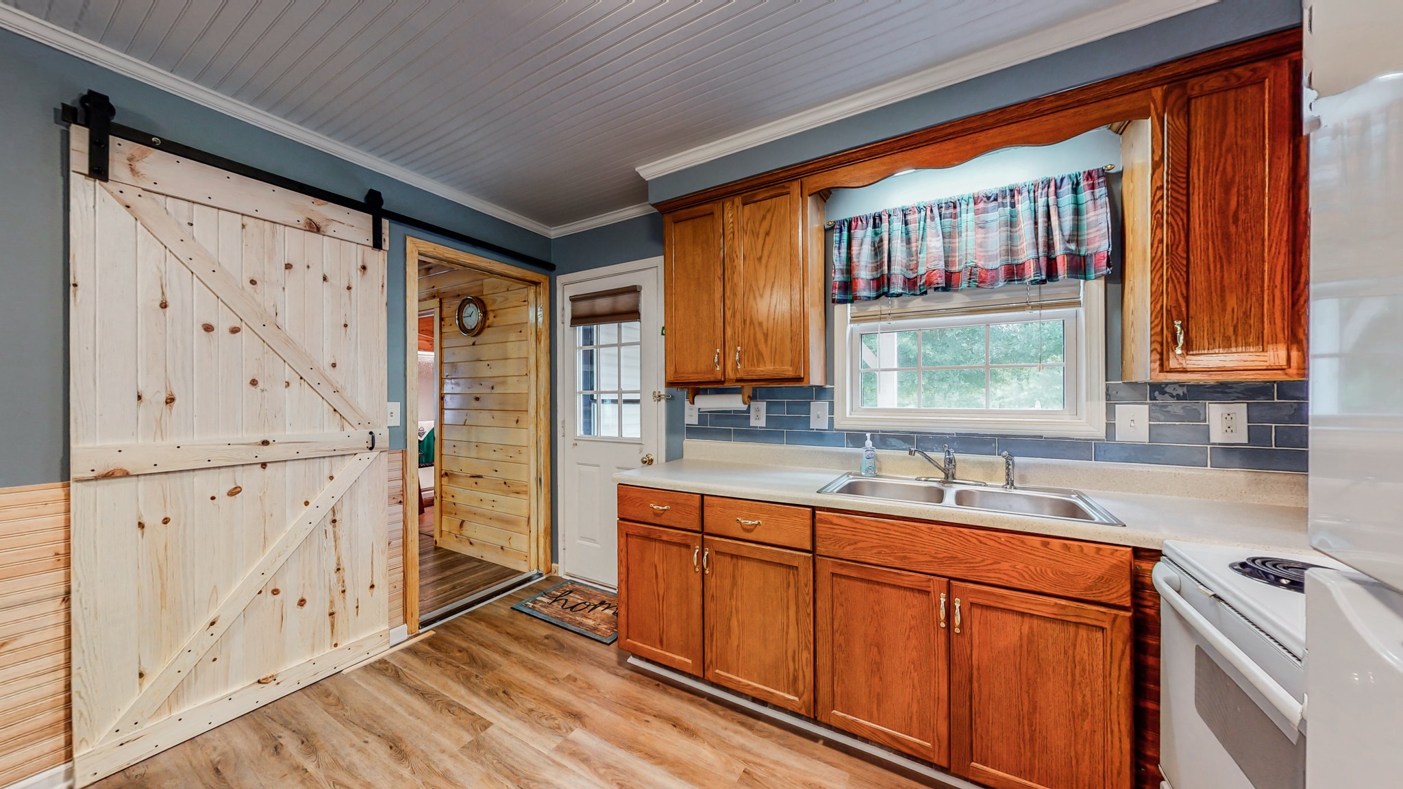 1243 White Road Bon Aqua, TN 37025 - Photo 14 of 42 a kitchen with stainless steel appliances sink cabinets and window