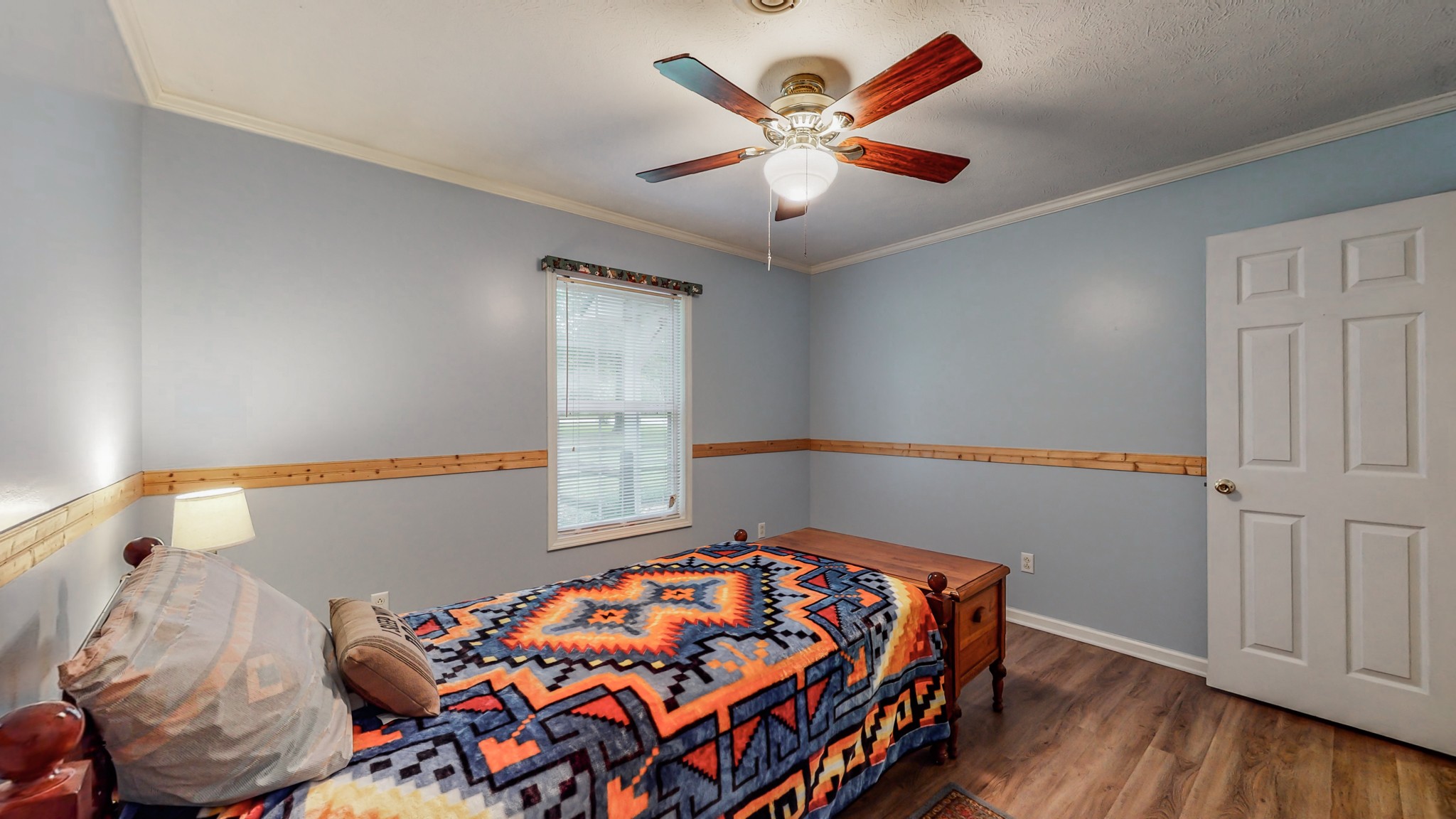1243 White Road Bon Aqua, TN 37025 - Photo 15 of 42 a bedroom with a bed and a chandelier