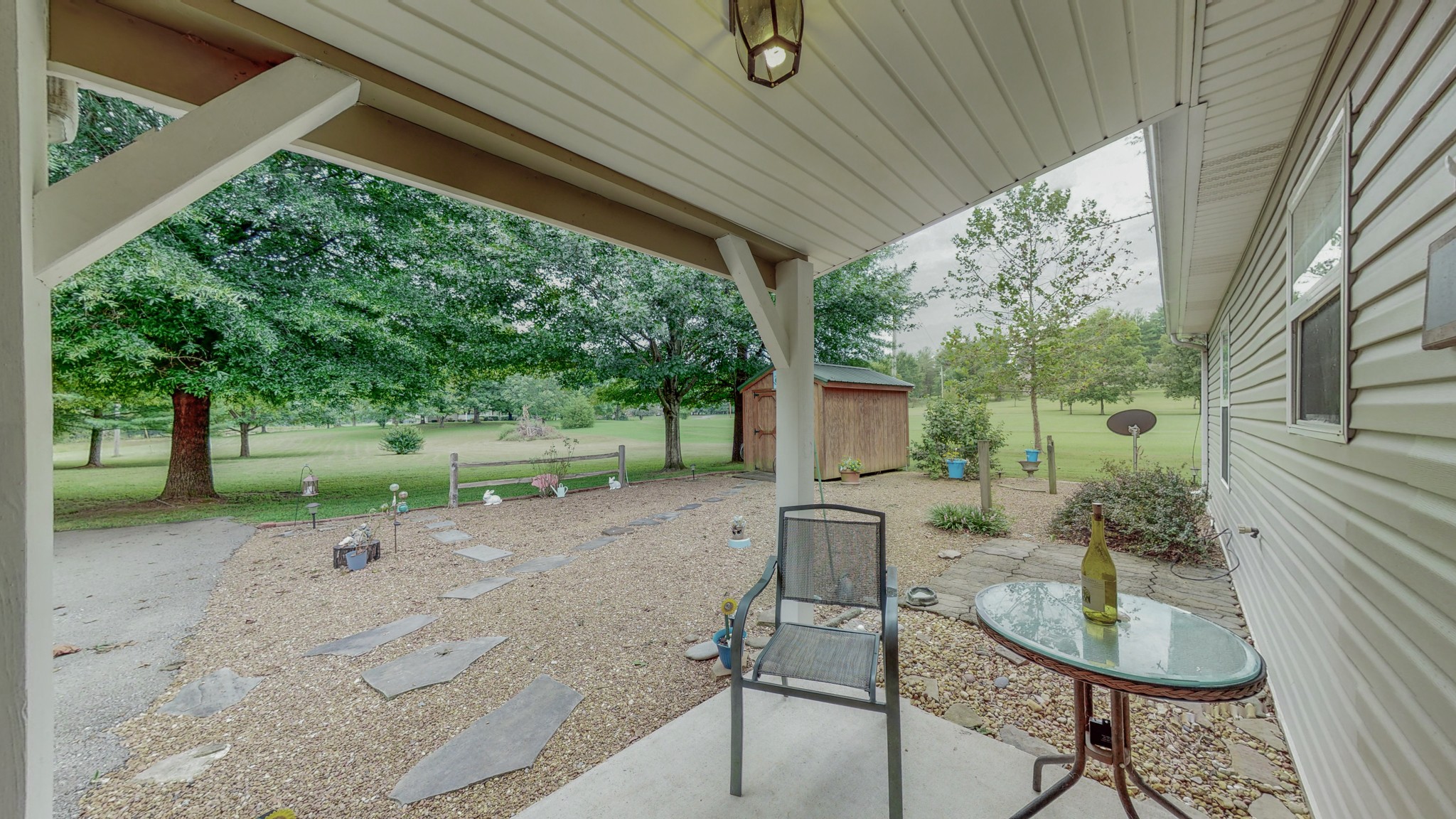 1243 White Road Bon Aqua, TN 37025 - Photo 39 of 42 a view of a backyard with table and chairs potted plants and large tree