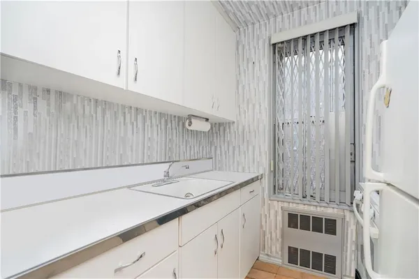 a kitchen with a sink and cabinets